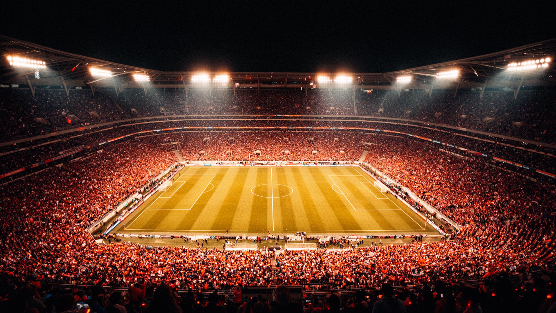 Aerial view of a packed football stadium at night